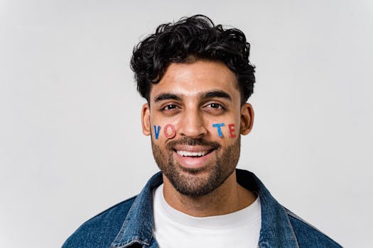 Portrait of a smiling man with the word 'vote' painted on his face, encouraging civic participation.