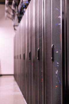 Row of similar lockers with various optic fiber cables in modern data server room
